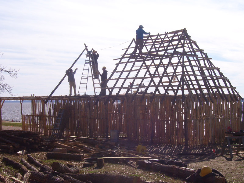 workers constructing a roof frame