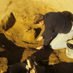 Archaeologist William Leigh excavating the cabasset helmet.