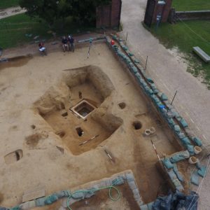 Aerial view of excavations next to brick gate