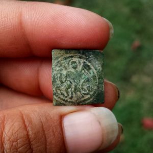 Square coin weight with biblical image
