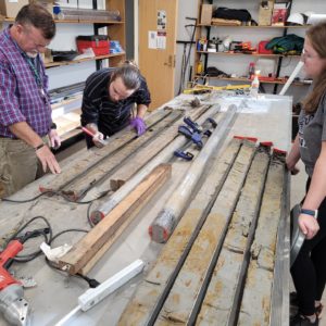 Director of Archaeology David Givens, Preston Senderoff, and graduate student Stephanie Scialo inspect the sediment in the core sample.