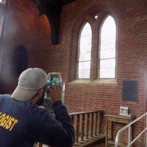 Archaeologist uses a transit station inside a church