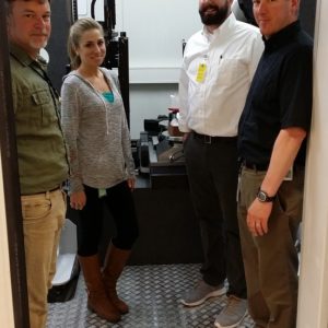 Staff standing in a technology lab