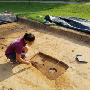 Student excavating a posthole