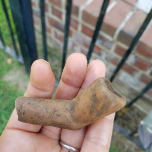Hand holding pipe bowl