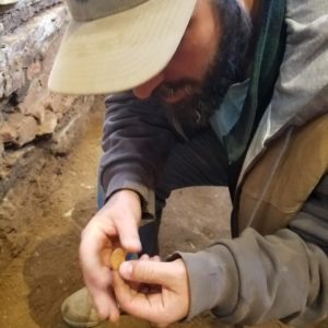 Archaeologist examines a bone disc