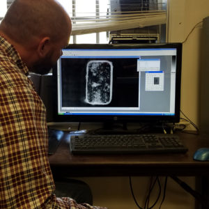 Man looking at x-ray on computer