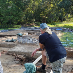 Two archaeologists stand in excavations