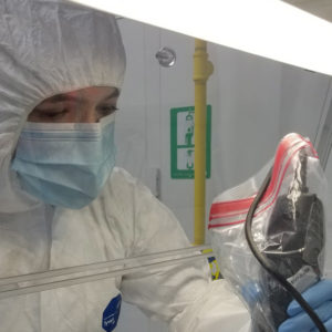 Dr. Fleskes in the clean room carefully removing the aDNA sample under an extraction hood.