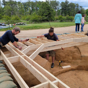 Archaeologists Gabriel Brown, Josh Barber, and Caitlin Delmas at work on the well observation platform.