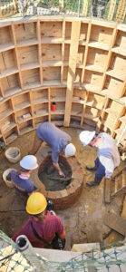 Archaeologists examine the sword blade in the Governor's Well.