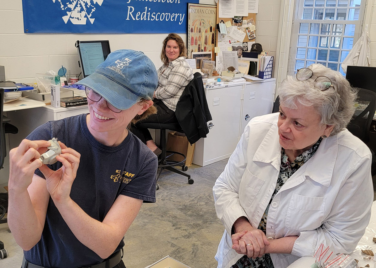 Staff Archaeologist Natalie Reid, Curator Leah Stricker, and Senior Curator Merry Outlaw (L-R) discover that a porcelain sherd found at the burial excavation area mends with a partial vessel already in the collection.