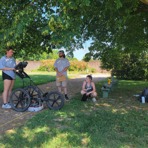Staff Archaeologist Caitlin Delmas instructs field school students Hope Clark, Richard Fallon, and Ellie Taylor in GPR techniques at Bacon's Castle.