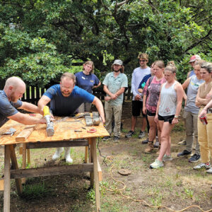 TerraSearch Geophysical's Dr. David Leslie and Senior Staff Archaeologist Sean Romo cut open one of the vibracore soil samples for analysis by field school students and staff.
