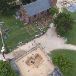 Aerial view of excavations by brick church