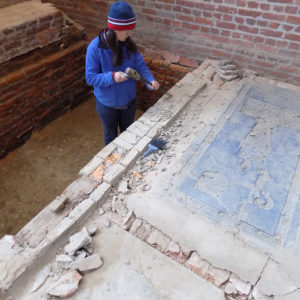 Archaeologist removes concrete from brick division