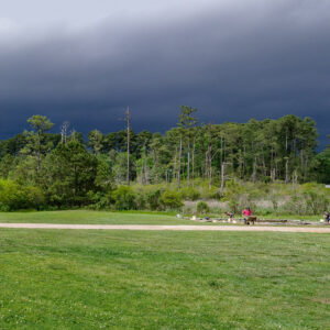 A storm passes north of Jamestown as archaeologists work at the pug mill site.