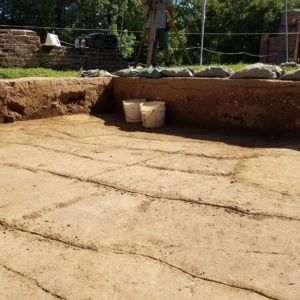 Archaeologist records planting furrows with a transit