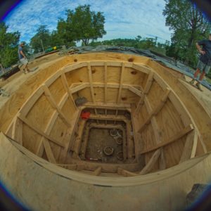 Fisheye view of well lined with wooden siding
