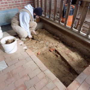 Archaeologist excavates brick church floor