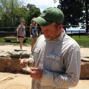 Archaeologist examining a ceramic sherd