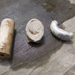 Two pipe fragments and one glass fragment