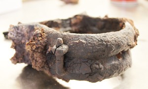 close-up view of a corroded semi-circular iron object