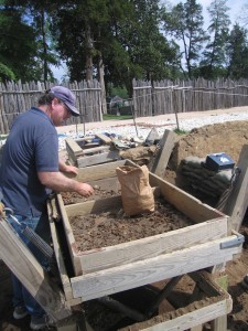 Archaeologist screening artifacts