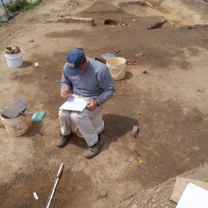 Archaeologist recording features