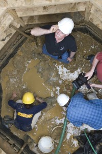 Archaeologists excavating a well