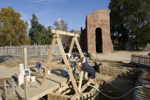 Archaeologists watch excavations of a well