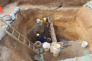 Archaeologists excavate a well
