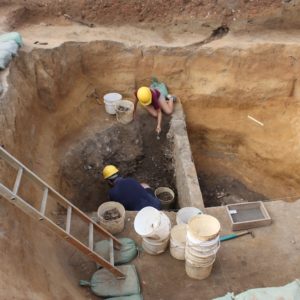 Archaeologists excavate a well