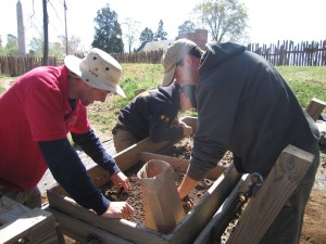 Archaeologists screen for artifacts