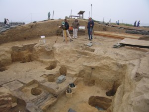 Archaeologists record cellar features with a transit station