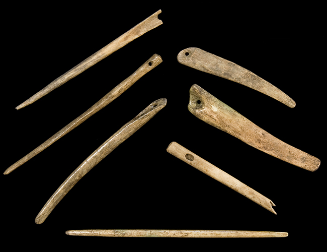 Seven bone needles with pierced hole on one end