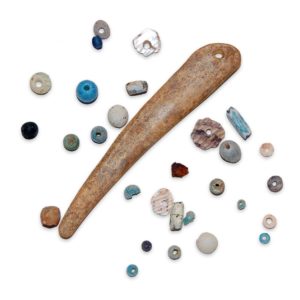 Bone needle and assortment of beads