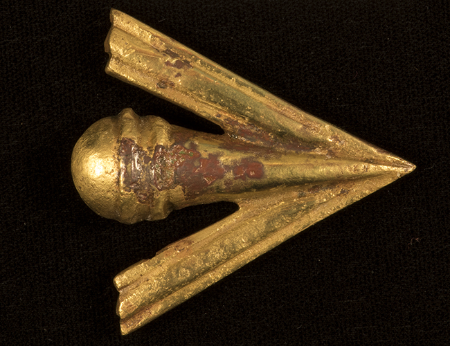 Cast brass mount in the shape of a broad arrow