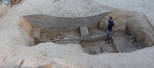 Archaeologist standing in an excavated cellar