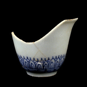 Mended Chinese porcelain wine cup with blue flame frieze decoration around base