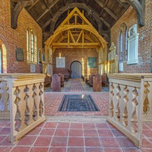 Church interior with wooden framing and chancel gate