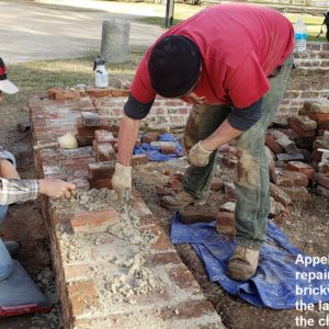 Conservators repair brick churchyard wall