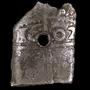 Sixpence clipped into a rectangular shape with a hole drilled into the middle