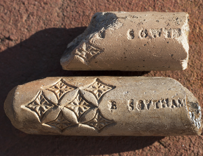 Two pipe fragments with stamped diamonds and letters, including *E SOVTHAM*