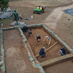 A different perspective of the North Church excavations. The team points to different features inside the squares containing the 1608 palisade extension.