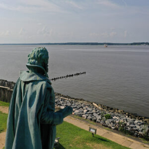 Captain John Smith watches Jamestown Settlement's Godspeed replica sail upriver.