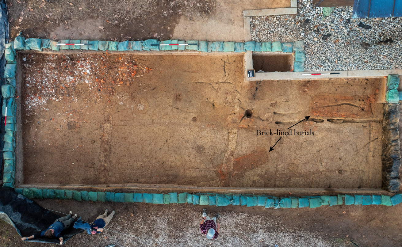 A drone shot of the excavations south of the Archaearium. The brick-lined burials are labeled. The brick/mortar rubble can be seen at the top-left of the excavation area.