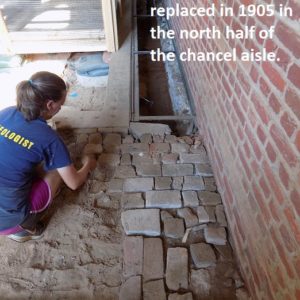 Archaeologist removes bricks from floor