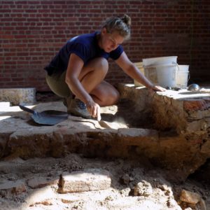 Archaeologist excavates features inside brick church