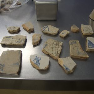Delftware tile sherds on a lab table